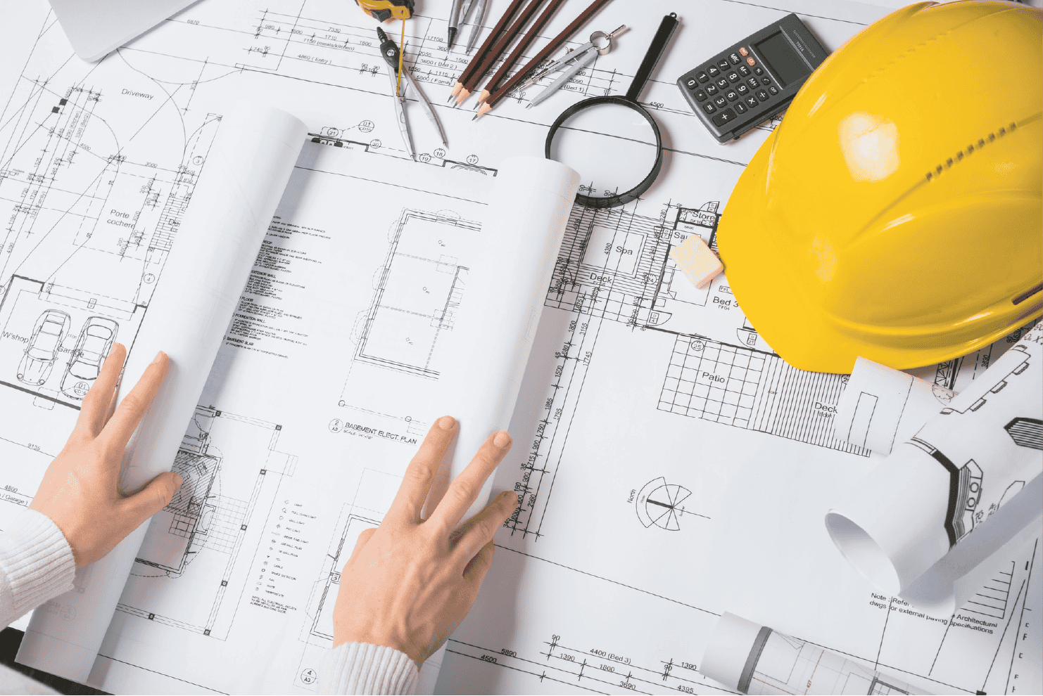 Blueprints and engineering tools for construction planning and design.